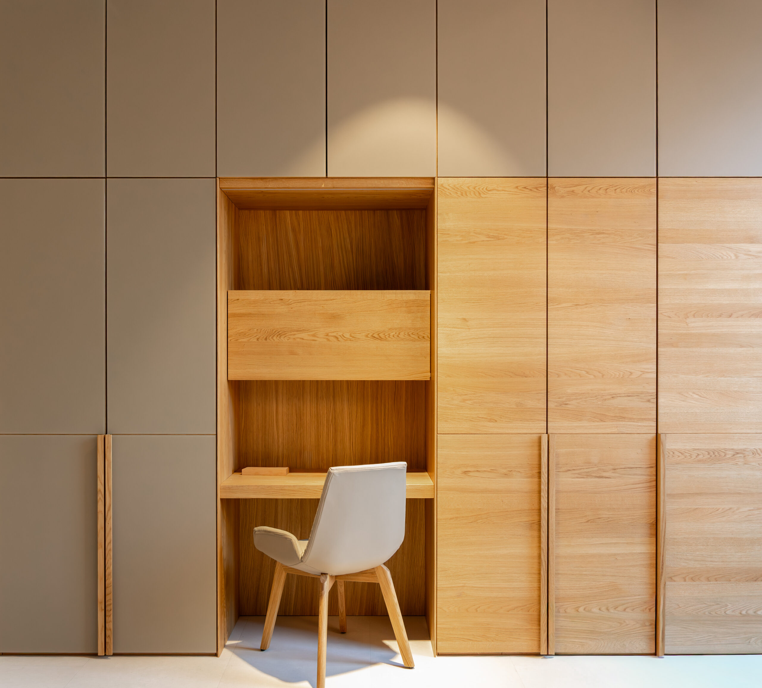 Modern cabinet with integrated workspace. Design of a wooden office interior.